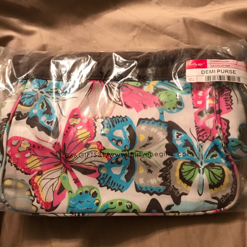 Thirty-One Demi Purse with a butterfly pattern.